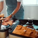Woman packing a suitcase, suitcase, packing, packing for vacation, packing a suitcase