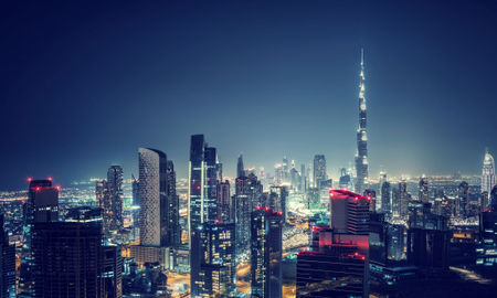 Beautiful Dubai cityscape, bird's eye view on a night urban scene, modern city panoramic landscape, United Arab Emirates (photo via Anna_Om / iStock / Getty Images Plus)