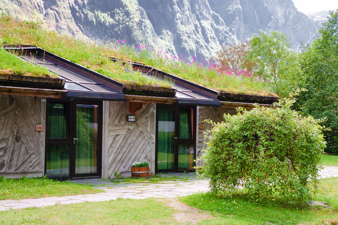Hotel with ecofriendly grass roof and solar panels.