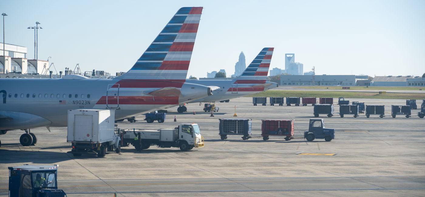 Image: American Airlines airplane at the gate of the Charlotte Douglas International Airport. (Photo Credit: Red Lemon / Adobe Stock)