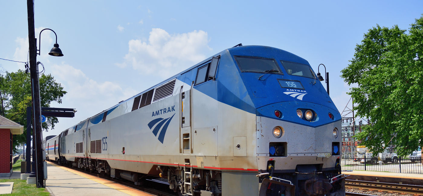 Image: Amtrak train parked at a station. (Photo Credit: Adobe Stock/Bruce Leighty)