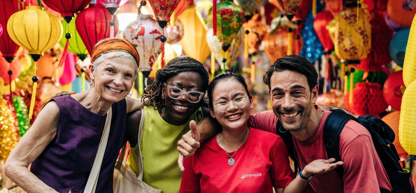 Image: An Intrepid Travel group and group leader pose for a photo in Hanoi, Vietnam. (Photo Credit: Intrepid Travel)