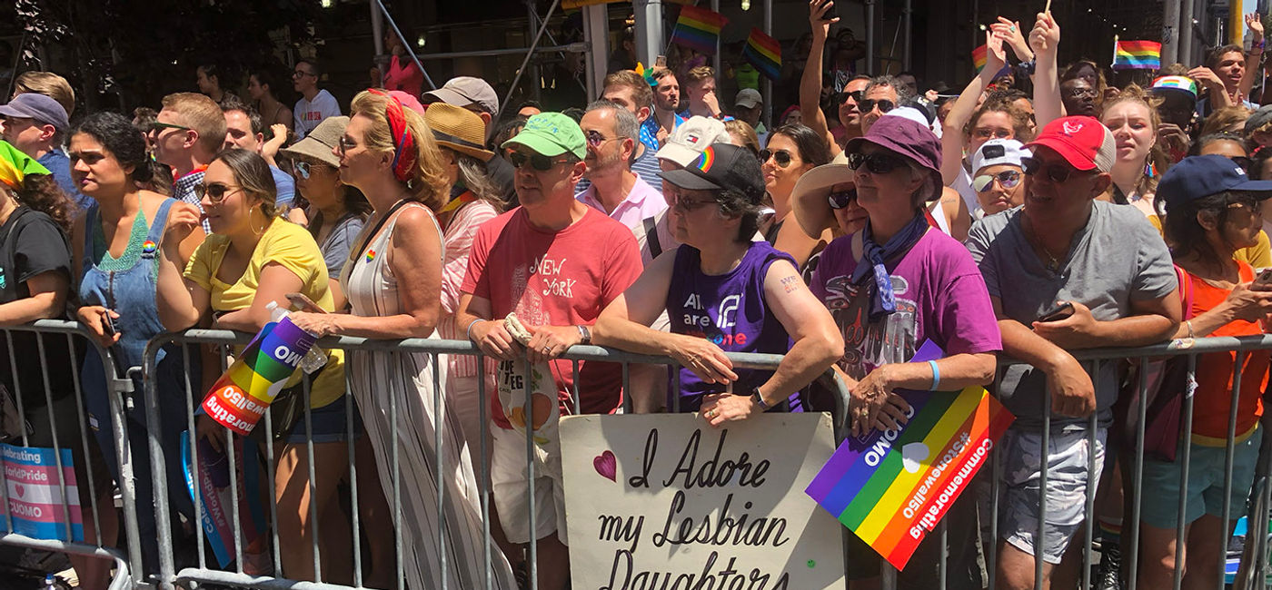 Image: Attendees watch the New York City Pride Parade in 2019. (Photo Credit: Photo by Paul Heney.)