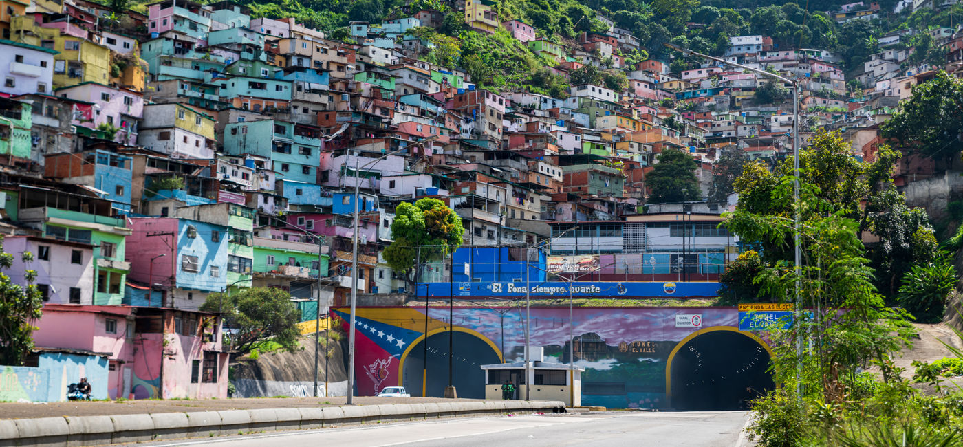 Image: Colorful buildings and houses adorn the hillsides in Caracas, Venezuela. (Photo Credit: Giongi63 / Adobe Stock)