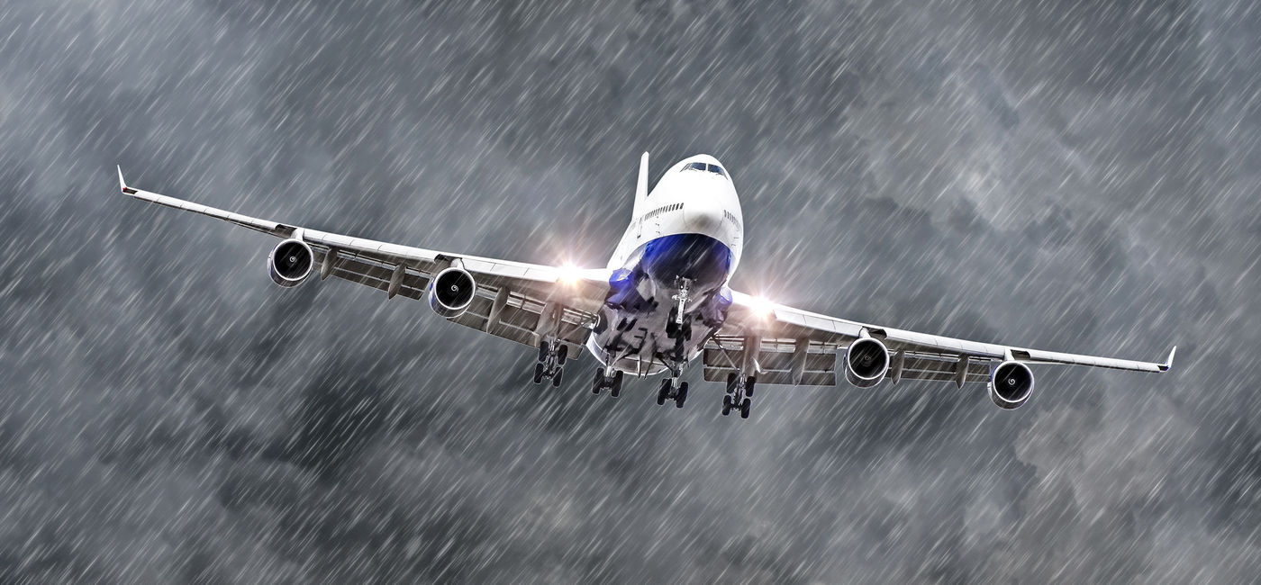 Image: Passenger airplane flying through a storm. (Photo Credit: Adobe Stock/aapsky)