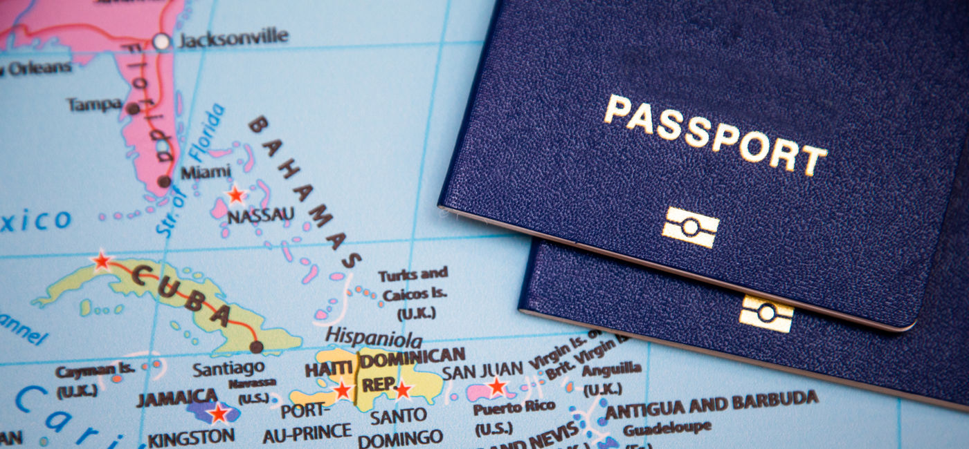 Image: Passports on a map of the Caribbean region. (Photo Credit: Adobe Stock/drotik)