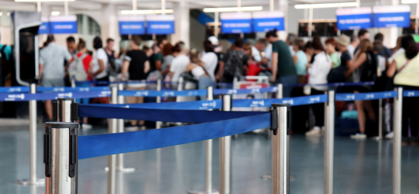 Image: Queue for customs and immigration screening at an airport. (Photo Credit: Adobe Stock/Oleg)