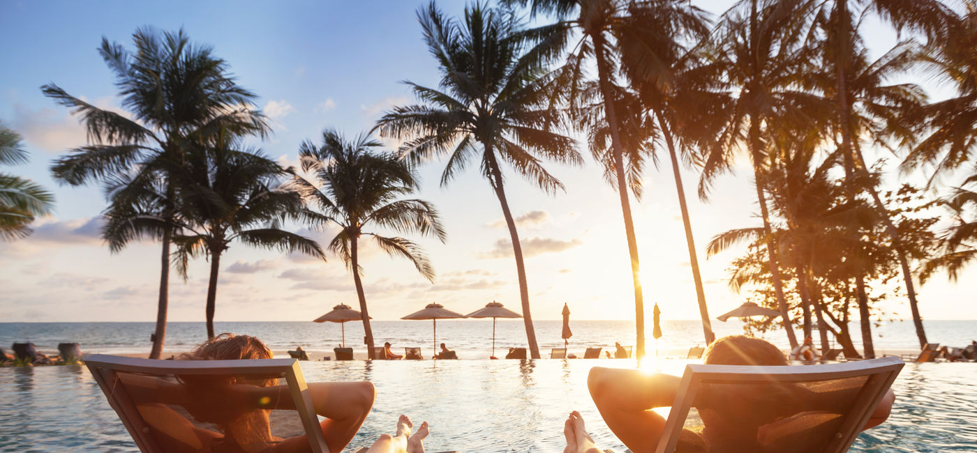 Image: Sitting poolside on a luxury vacation (Photo Credit: Song_about_summer/Adobe Stock)