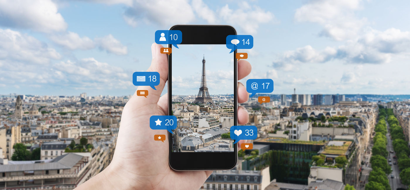 Image: Smart phone taking a photo of the Eiffel Tower to post on social media. (Photo Credit: Adobe Stock/SasinParaksa)