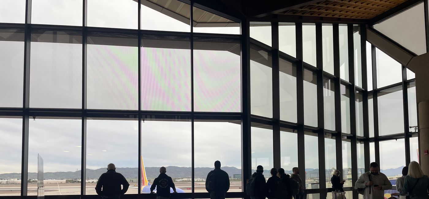 Image: Travelers look on at Phoenix Sky Harbor International Airport. (Photo Credit: Patrick Clarke)