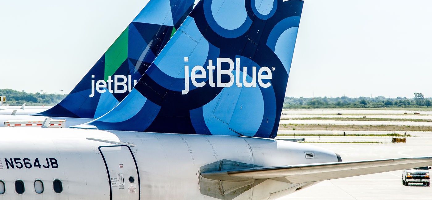 Image: Two JetBlue airplanes parked. (Photo Credit: Roman Tiraspolsky / Adobe Stock)