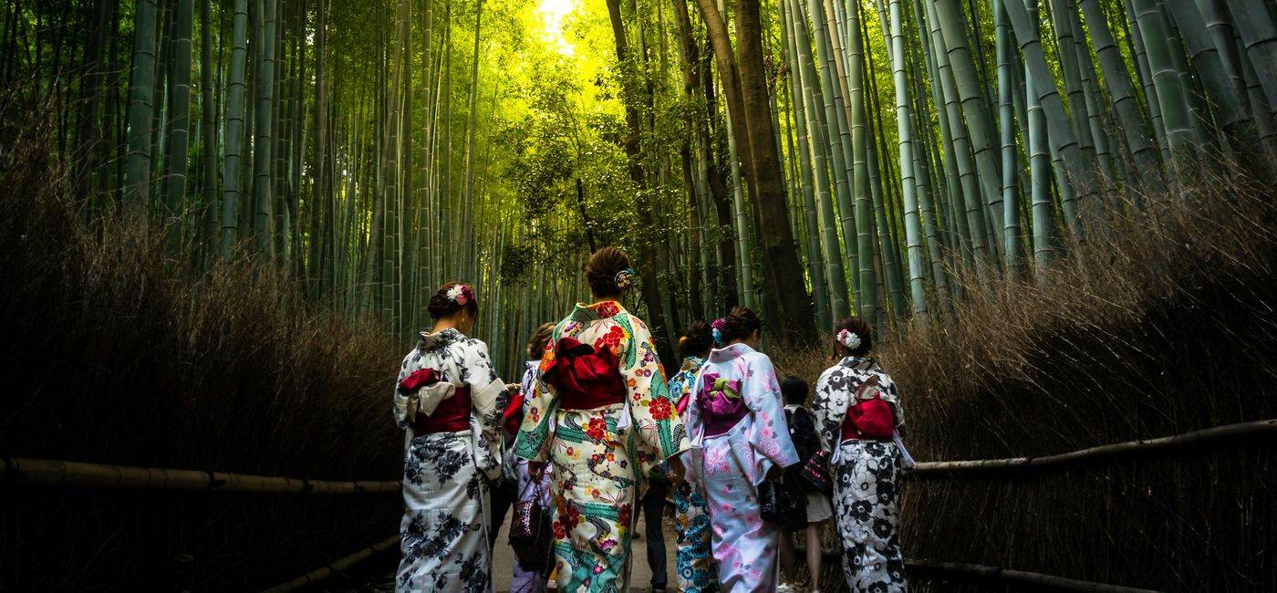 Image: Women in traditional Japanese kimono walk together in a bamboo forest in Japan. (Photo Credit: Swan Hellenic via Gio Almonte, Unsplash)