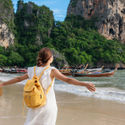 Young female traveler enjoying a summer vacation on a tropical beach in Krabi, Thailand.
