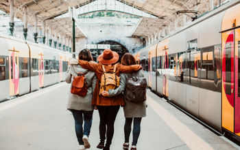 A group of young friends waiting at the station in Porto, Portugal before catching a train.