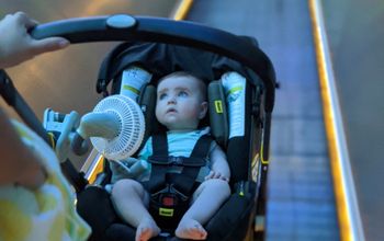 Battery-powered fan attached to a stroller walking through the airport