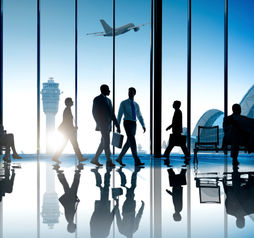 Corporate or business travelers walking through the airport.